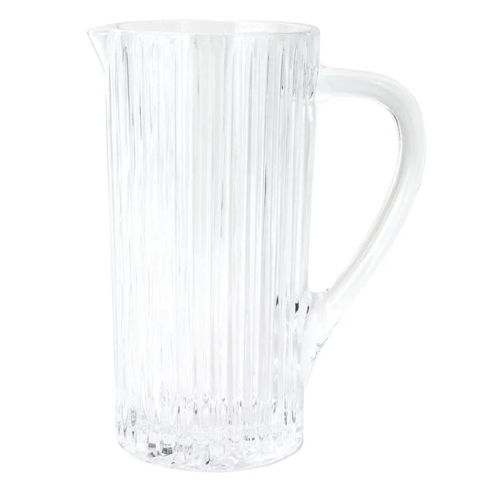 Vietri Natalia Pitcher in clear glass features vertical textured lines, a wide spout, and a large handle, shown against a white background.