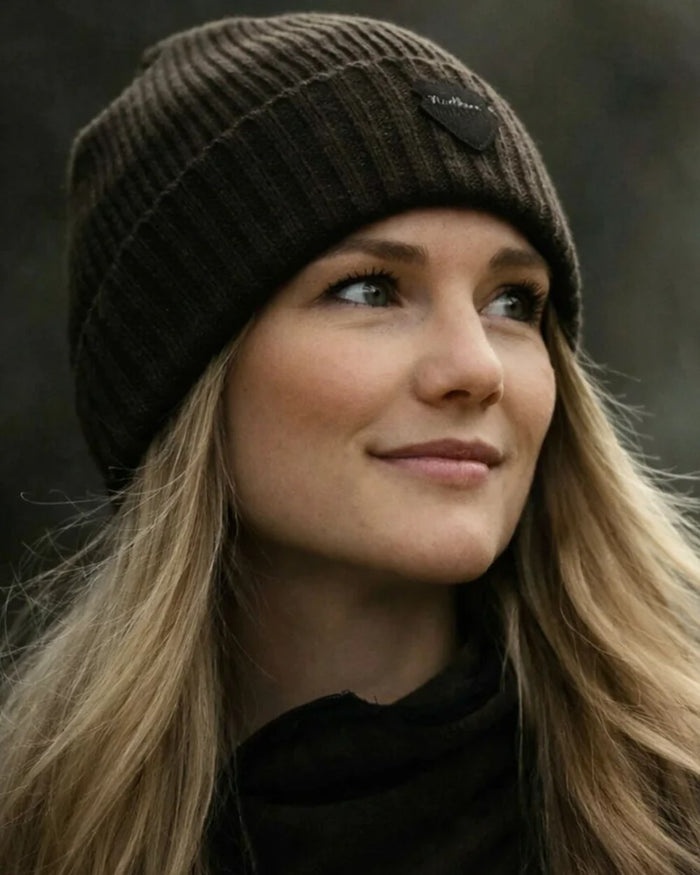 Green coloured Northern Hunting Buk Windstop Beanie on forest background #colour_green