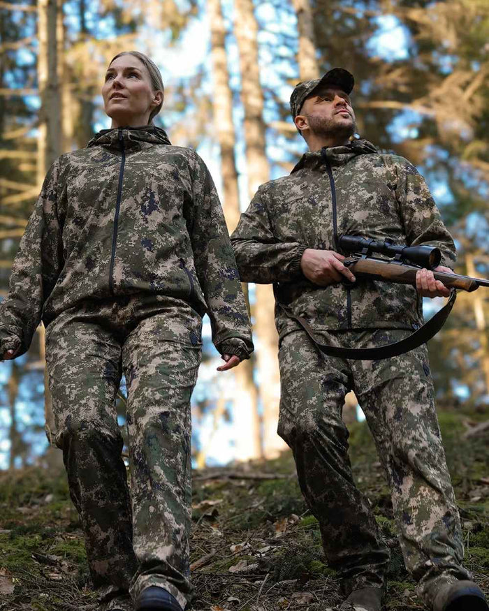 Camo coloured Northern Hunting Kjell Balk Tanatex Hunting Trousers on forest background #colour_camo