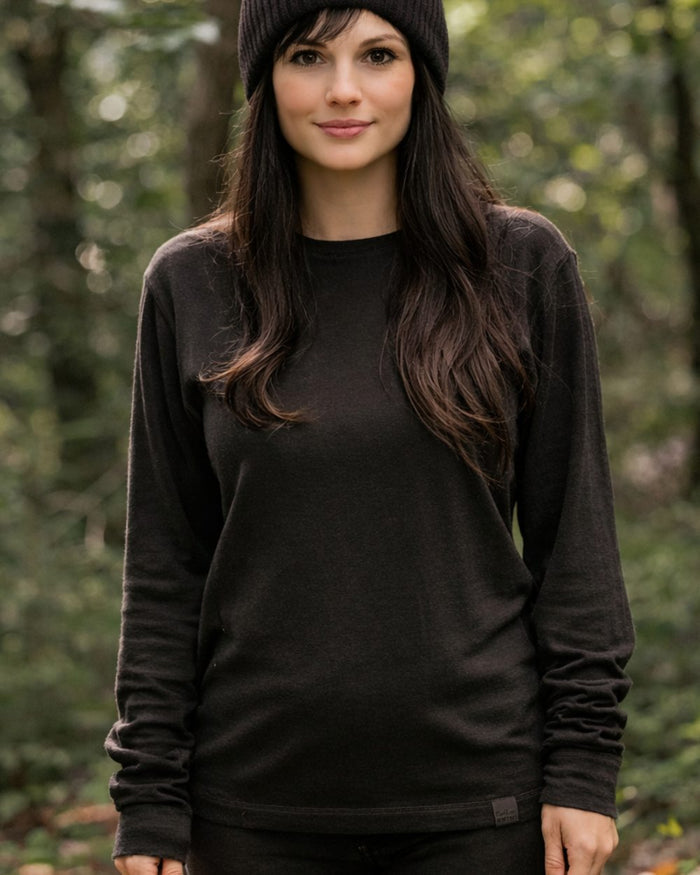 Dark Green coloured Northern Hunting Norr Vik Long Sleeve Baselayer Top on forest background #colour_dark-green