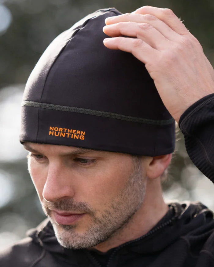 Dark Green Opt2 coloured Northern Hunting Rune Reversible Stretch Beanie on forest background #colour_dark-green-opt2