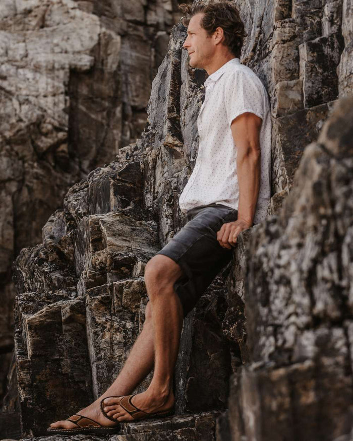 Sand coloured Orca Bay Mens Belize Sandals on rock background #colour_sand