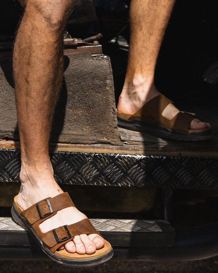 Sand coloured Orca Bay Mens Carbis Sandals on outdoor background #colour_sand