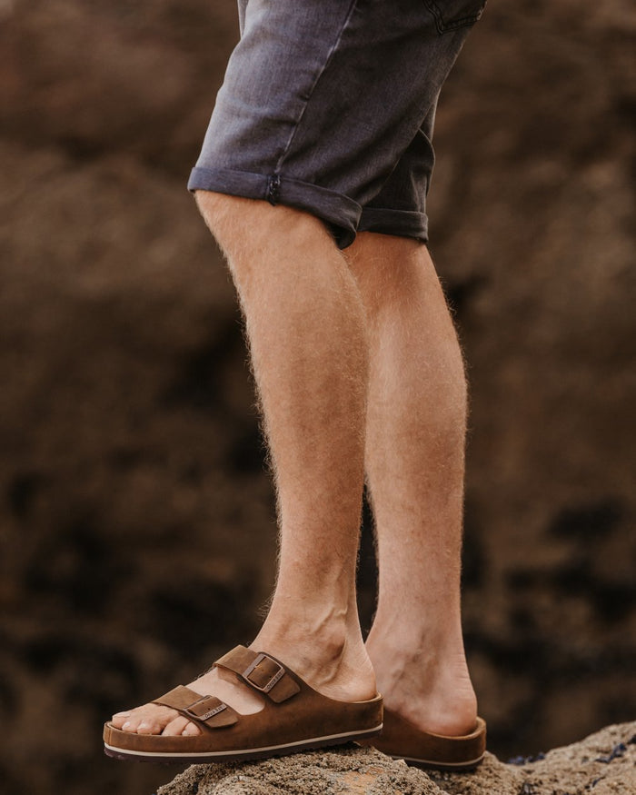 Dark Brown coloured Orca Bay Mens Saba Sandals on stone background #colour_dark-brown