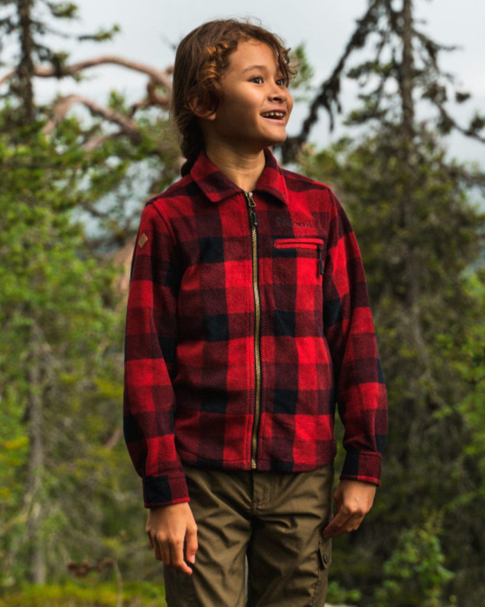 Red Black coloured Pinewood Childrens Canada Fleece Shirt on forest background #colour_red-black