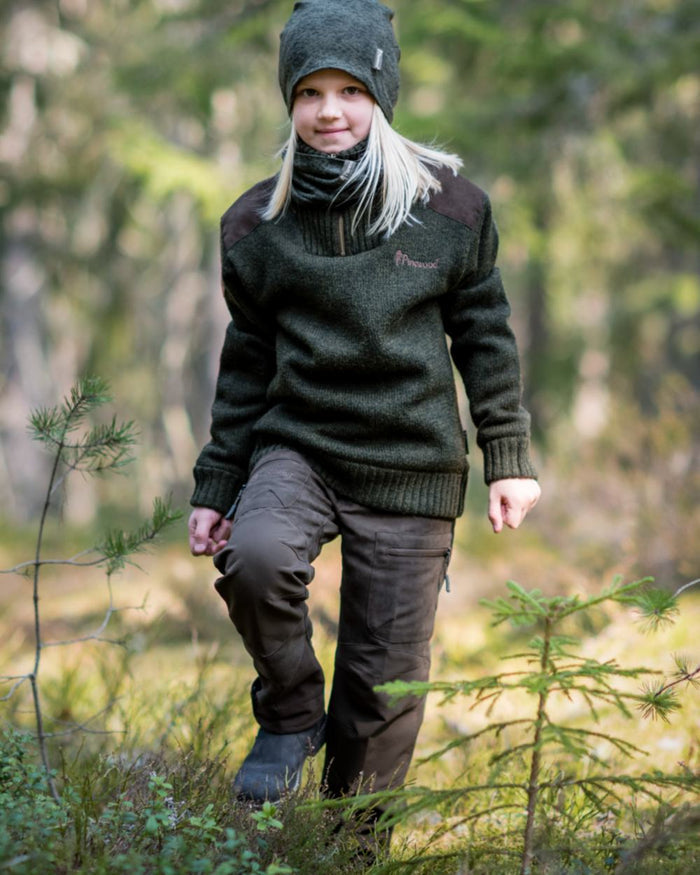 Suede Brown Dark Olive coloured Pinewood Childrens Caribou Hunt Trousers on forest background #colour_suede-brown-dark-olive