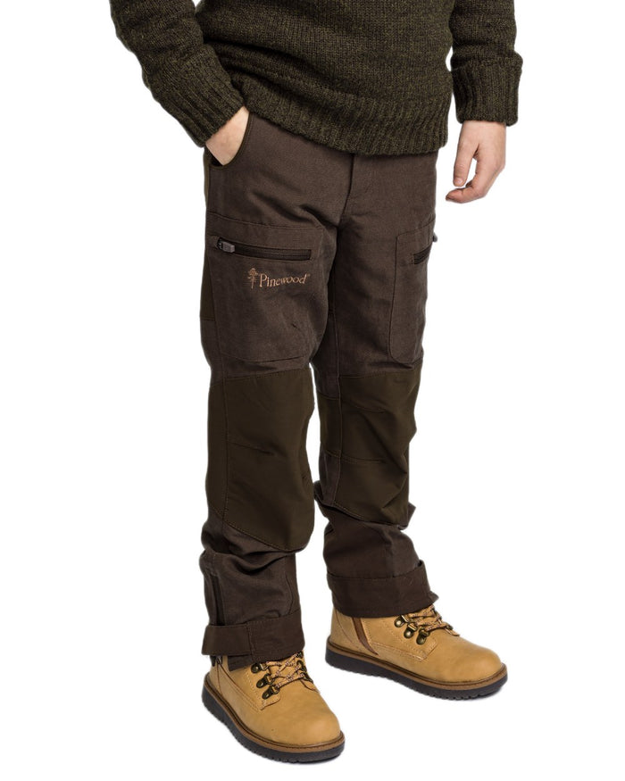 Suede Brown Dark Olive coloured Pinewood Childrens Caribou Hunt Trousers on white background #colour_suede-brown-dark-olive