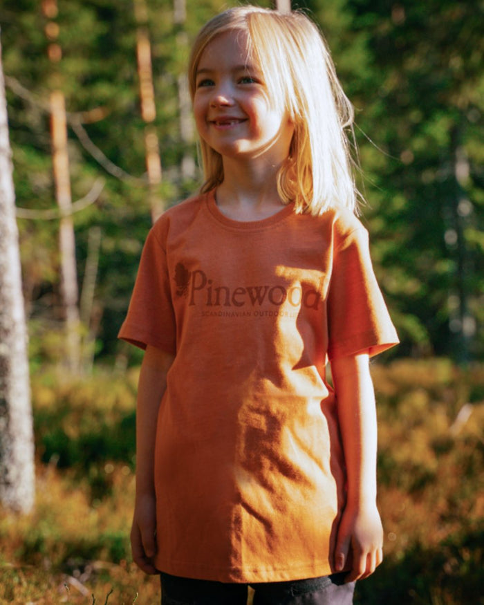 Light Terracotta coloured Pinewood Childrens Outdoor Life T-Shirt on forest background #colour_light-terracotta