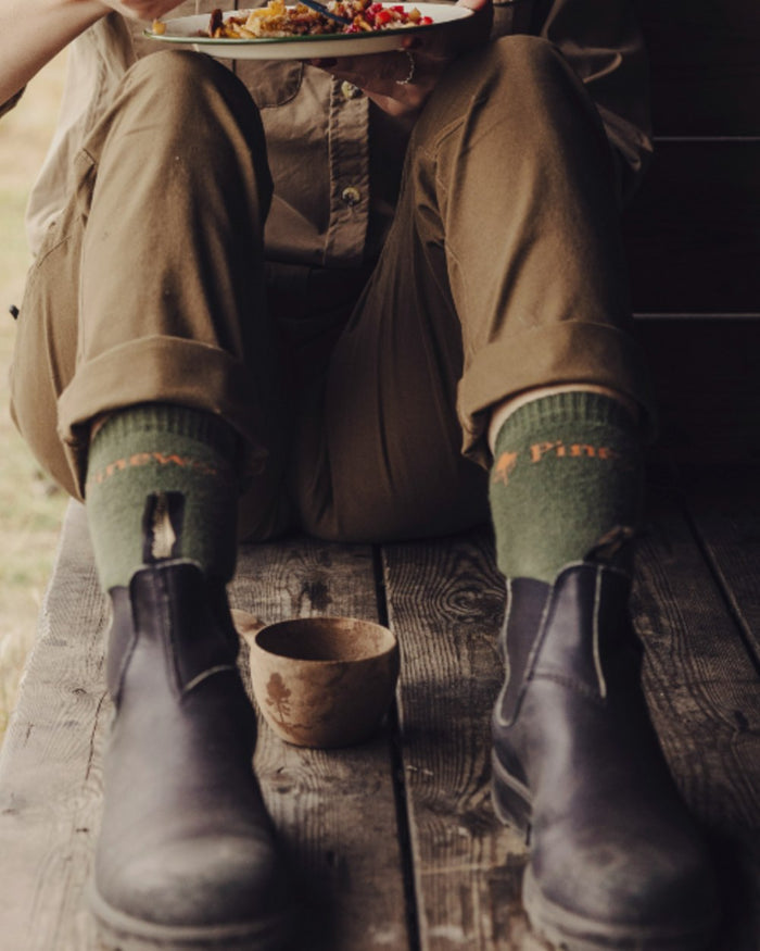 Olive coloured Pinewood Insectsafe Long Socks on outdoor background #colour_olive