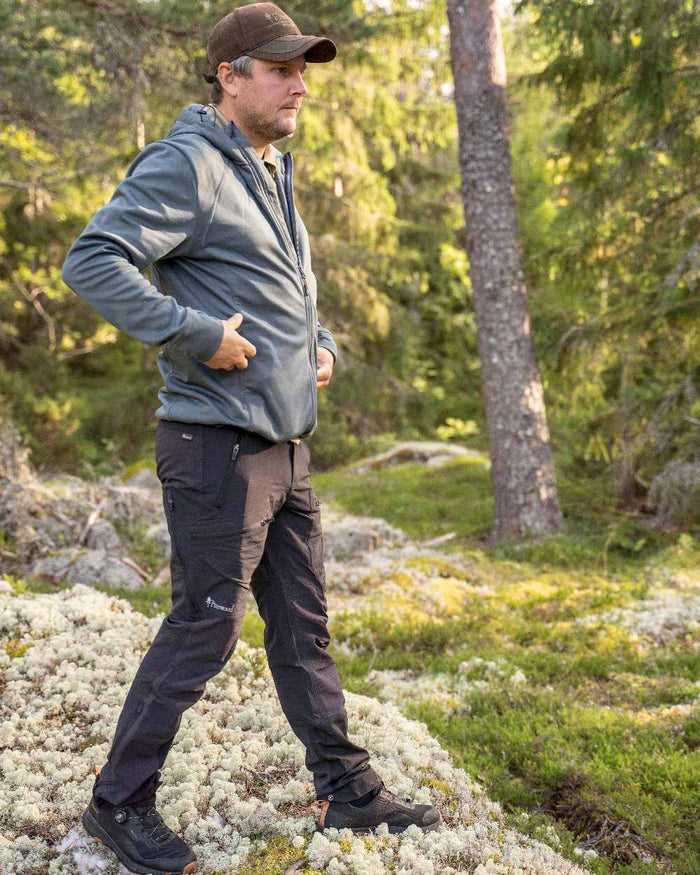 Black Coloured Pinewood Mens Abisko Adventure Trousers on outdoor background #colour_black