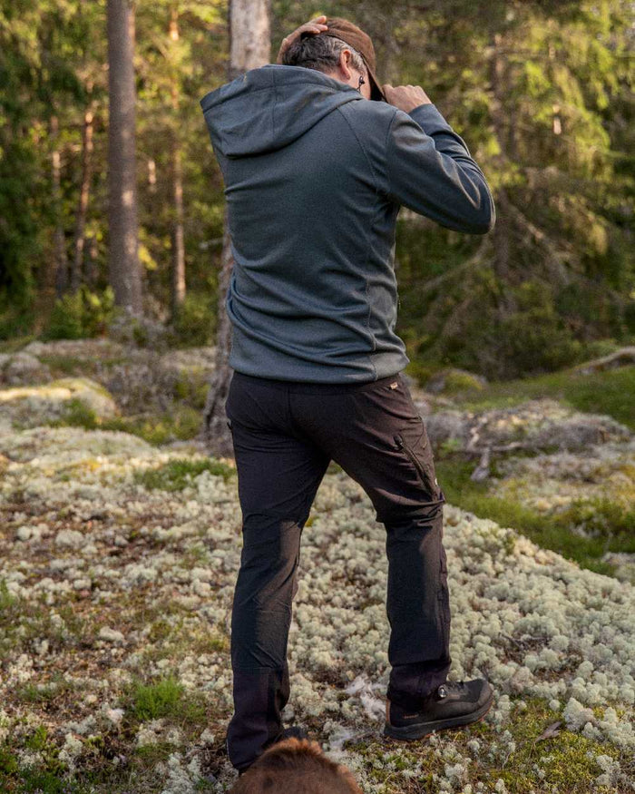 Black Coloured Pinewood Mens Abisko Adventure Trousers on outdoor background #colour_black
