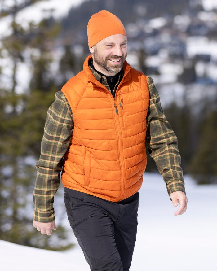 Burned Orange Coloured Pinewood Mens Abisko Insulation Vest on snow background #colour_burned-orange