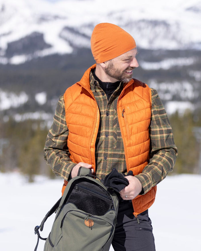 Burned Orange Coloured Pinewood Mens Abisko Insulation Vest on snow background #colour_burned-orange
