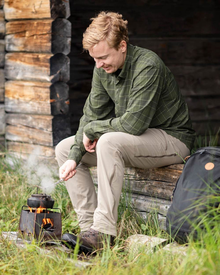 Moss Green Coloured Pinewood Mens Abisko Trekking Long Sleeve Shirt on outdoor background #colour_moss-green