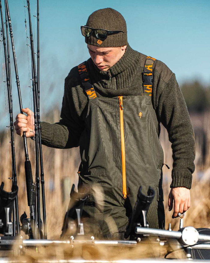 Green Dark Green Coloured Pinewood Mens Bolmen Fishing Bib Trousers on outdoor background #colour_green-dark-green