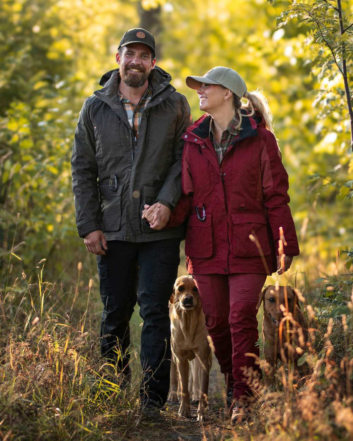 Moss Green Coloured Pinewood Mens Dog Sports Trainer Jacket on outdoor background #colour_moss-green