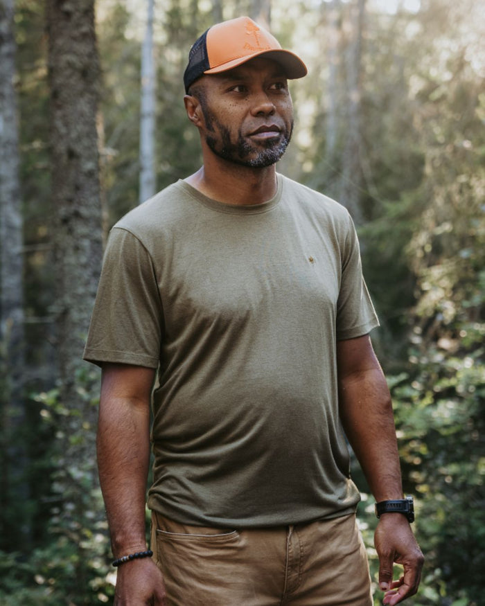 Olive Green coloured Pinewood Mens Finnveden Forest T-Shirt on forest background #colour_olive-green