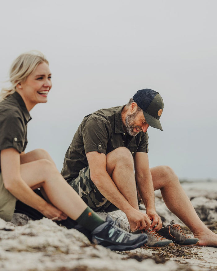 Dark Olive Coloured Pinewood Mens Safari Short Sleeve Shirt on outdoor background #colour_dark-olive