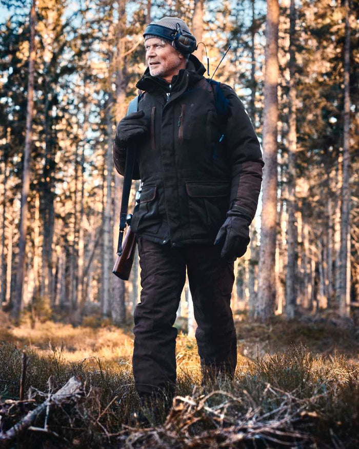 Suede Brown Coloured Pinewood Mens Smaland Abisko 2.0 Hunting Trousers on outdoor background #colour_suede-brown