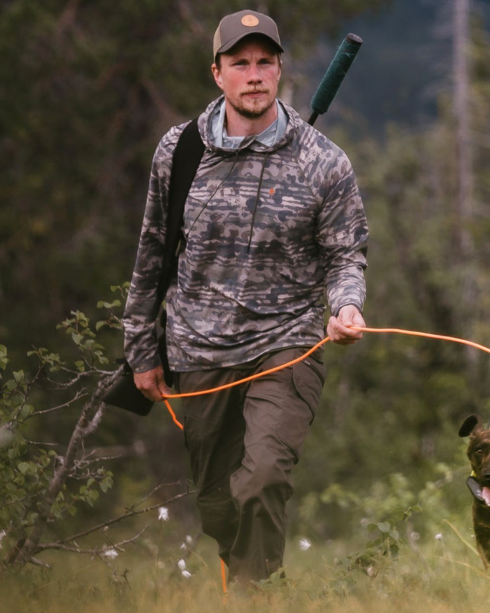 Dark Olive coloured Pinewood Mens Smaland Hunters Insectsafe Trousers on forest background #colour_dark-olive