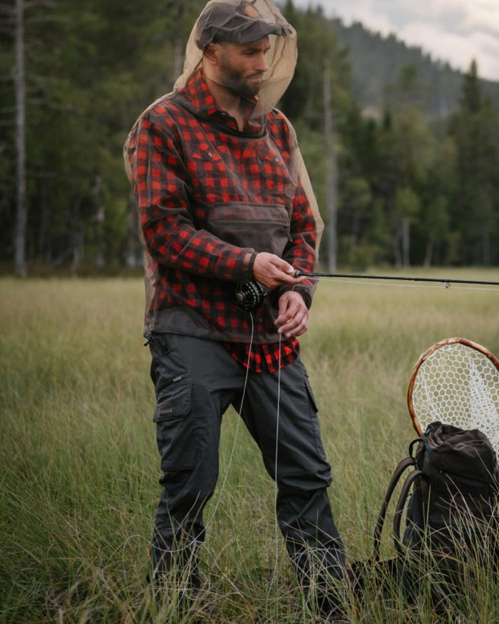 Moss Green coloured Pinewood Mens Smaland Hunters Insectsafe Trousers on forest background #colour_moss-green