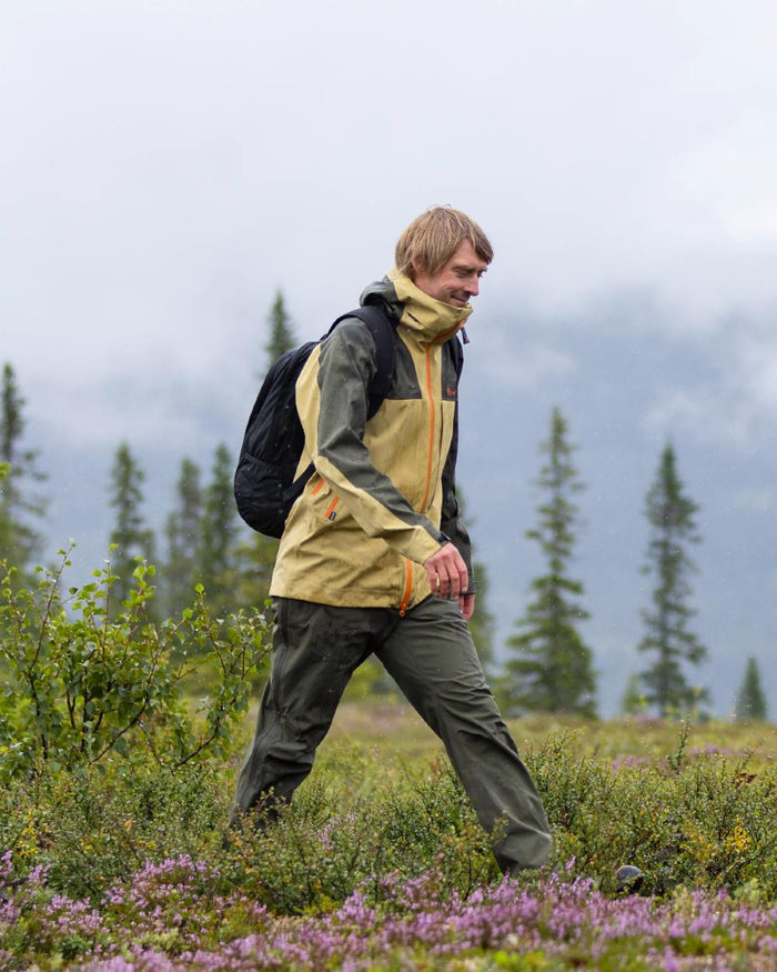 Moss Green Coloured Pinewood Mens Telluz Trousers on forest background #colour_moss-green