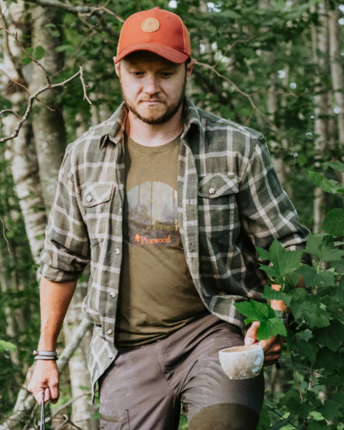 Olive coloured Pinewood Mens Wild Boar T-Shirt on forest background #colour_olive