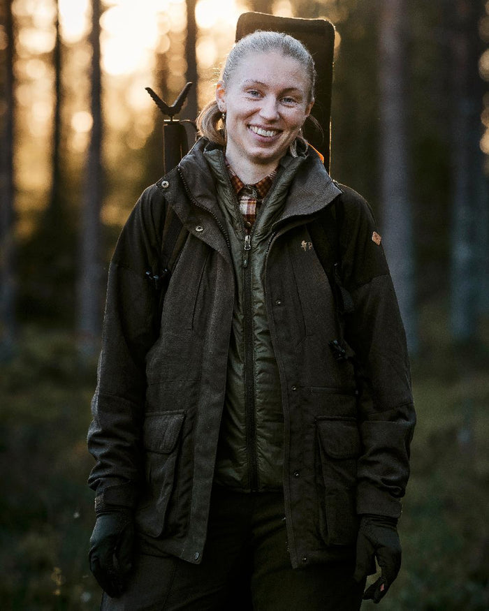 Moss Green Coloured Pinewood Thin Liner Gloves on outdoor background #colour_moss-green