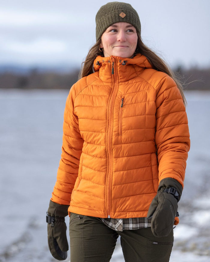 Burned Orange Coloured Pinewood Womens Abisko Insulation Jacket on snow background #colour_burned-orange