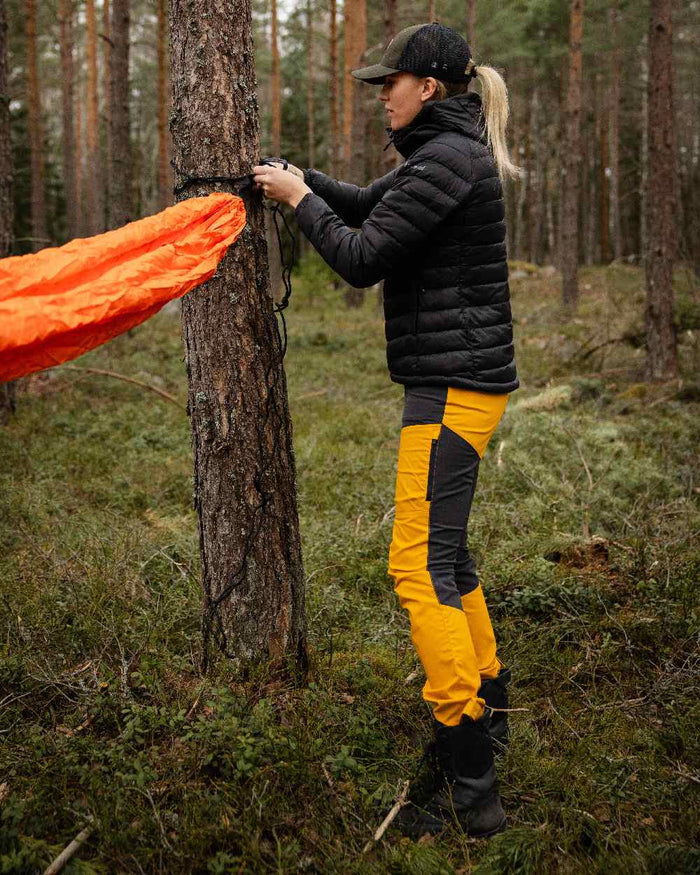 Black Coloured Pinewood Womens Abisko Insulation Jacket on forest background #colour_black