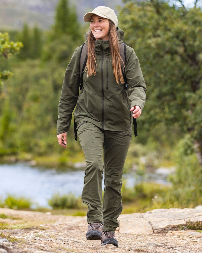 Mossgreen Coloured Pinewood Womens Abisko Light Stretch Trousers on outdoor background #colour_mossgreen