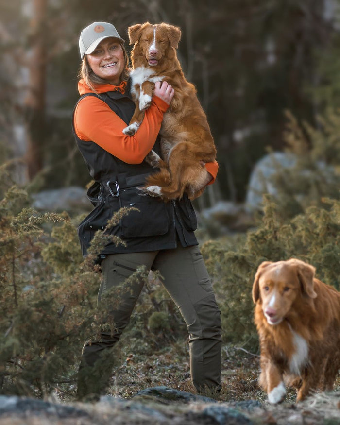 Black Coloured Pinewood Womens Dog Sports Trainer Vest on forest background #colour_black