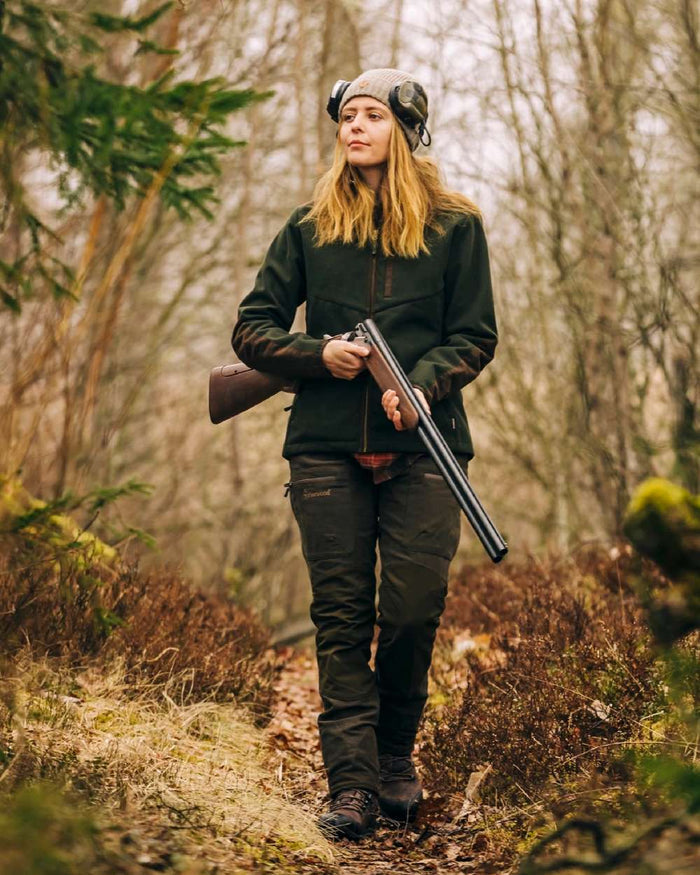Suede Brown Dark Olive Coloured Pinewood Womens Furudal Caribou Hunt Trousers on forest background #colour_suede-brown-dark-olive