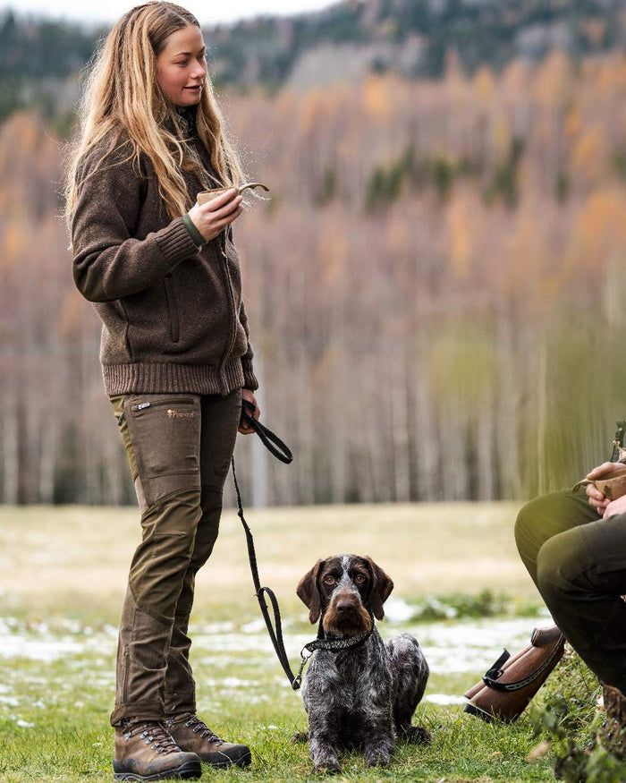 Suede Brown Dark Olive Coloured Pinewood Womens Furudal Caribou Hunt Trousers on forest background #colour_suede-brown-dark-olive