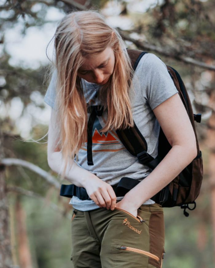 Light Grey Melange coloured Pinewood Womens Outdoor Trekker T-Shirt on forest background #colour_light-grey-melange