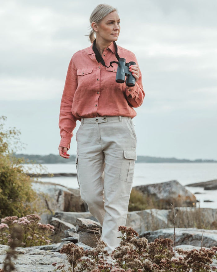 Linen Beige coloured Pinewood Womens Varnamo Insectsafe Linen Trousers on sea background #colour_linen-beige