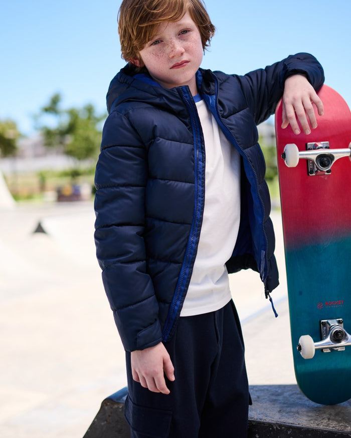 Navy New Royal coloured Regatta Professional Childrens Thermal Jacket on outdoor background #colour_navy-new-royal