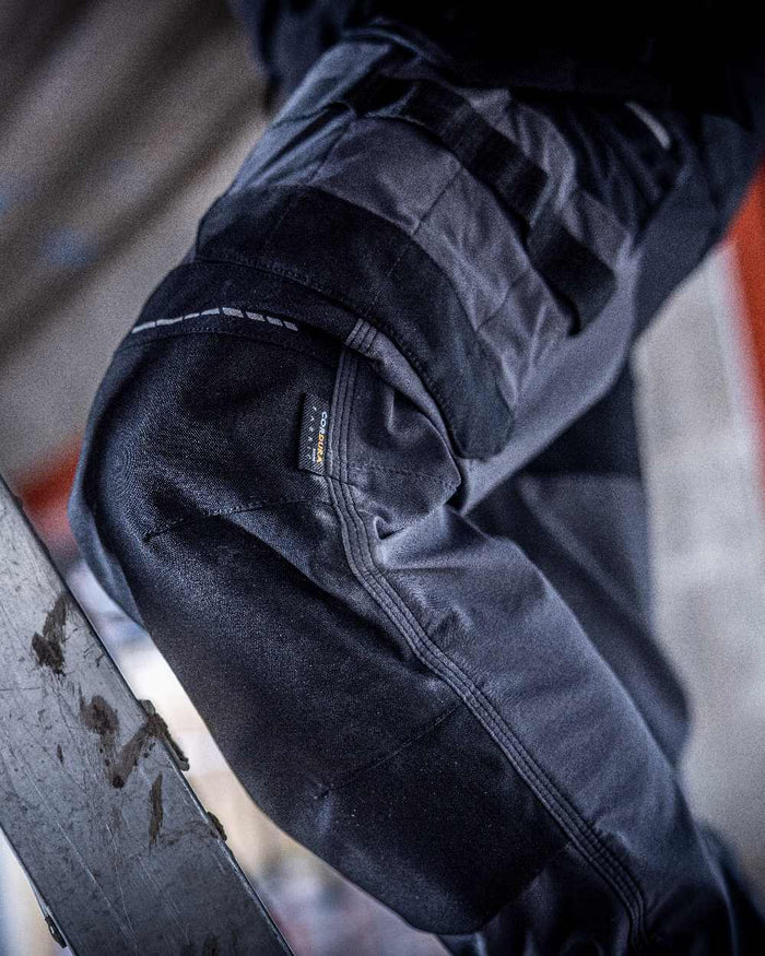 Slate Grey Black coloured Regatta Mens 4Tex Stretch Holster Trousers on wall background #colour_slate-grey-black