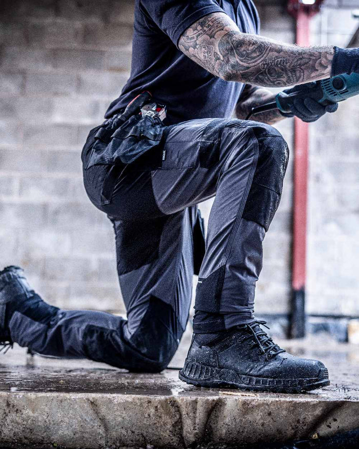 Slate Grey Black coloured Regatta Mens 4Tex Stretch Holster Trousers on wall background #colour_slate-grey-black