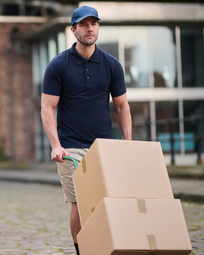 Navy coloured Regatta Professional Mens 65/35 Short Sleeves Polo Top on outdoor background #colour_navy