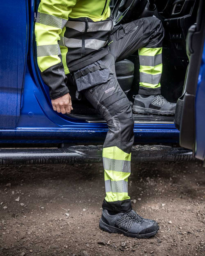 Black Yellow Coloured Regatta Mens Hi-Vis X-Pro Stretch Holster Trousers Class 1 on Outdoor Background
#colour_black-yellow