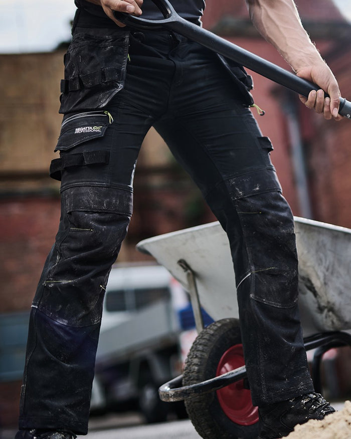 Black coloured Regatta Mens Infiltrate Softshell Stretch Trousers on blurry background #colour_black