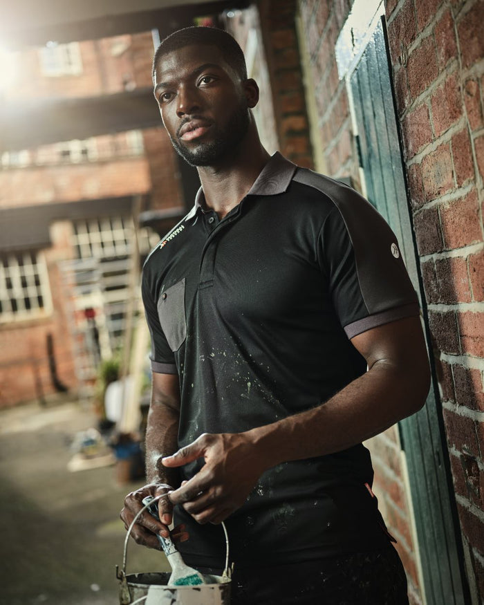 Black coloured Regatta Mens Offensive Moisture Wicking Polo Shirt on blurry background #colour_black