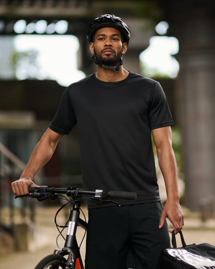 Black coloured Regatta Professional Mens Pro Wicking T-Shirt on outdoor background #colour_black