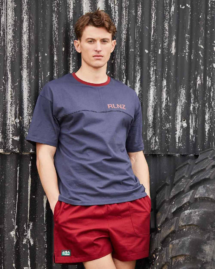 Rhubarb coloured Ridgeline Hose Down Shorts on black wall background #colour_rhubarb