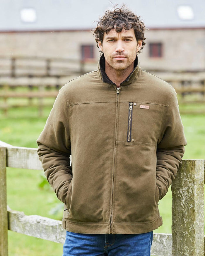 Moody Teak coloured Ridgeline Mens Montana Work Coat on farm background #colour_moody-teak