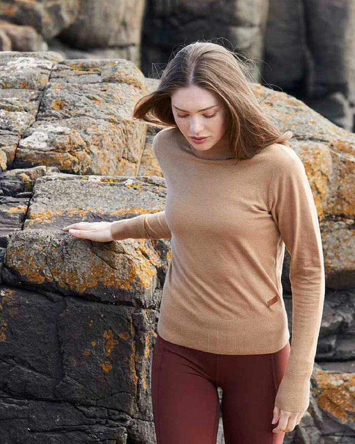 Sienna coloured Ridgeline Womens Melford Knit Roll Neck Jumper on rocky background #colour_sienna