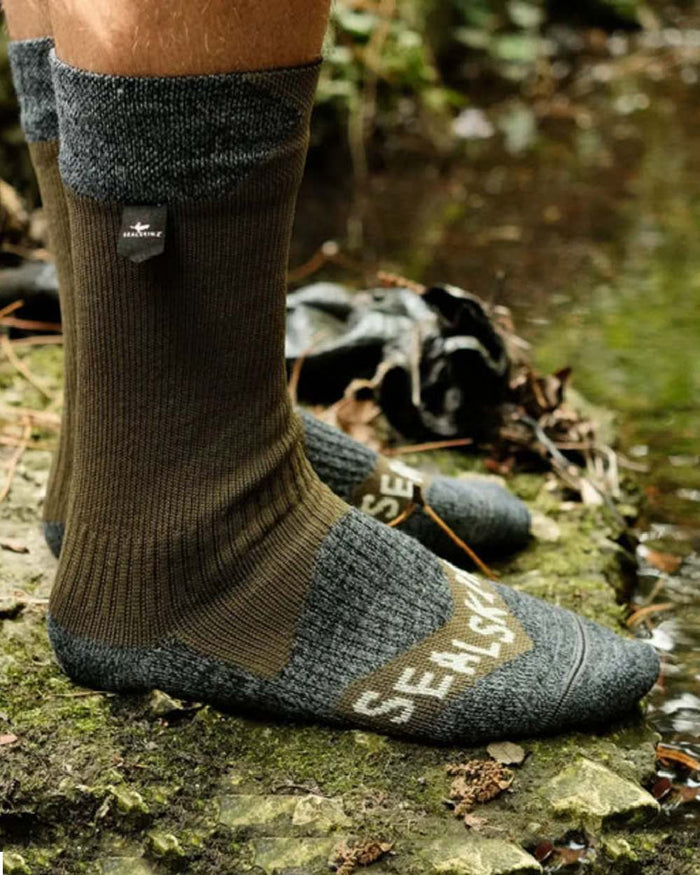 Olive Coloured Sealskinz Raynham Waterproof All Weather Mid Length Sock on outdoor background #colour_olive