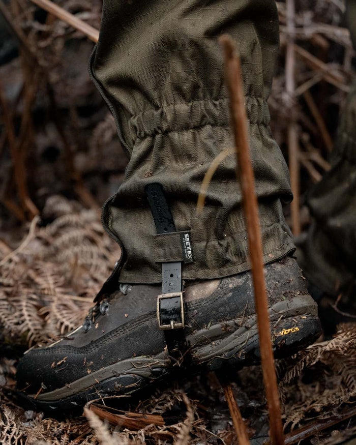 Shaded Olive coloured Seeland Buckthorn Duro Gaiters on forest background #colour_shaded-olive