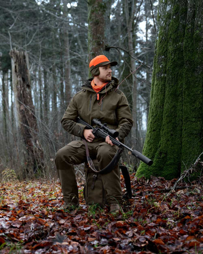 Pine Green coloured Seeland Enduro Chair Backpack on forest background #colour_pine-green